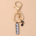 Piano and Music Note Keychain in Gold Tone