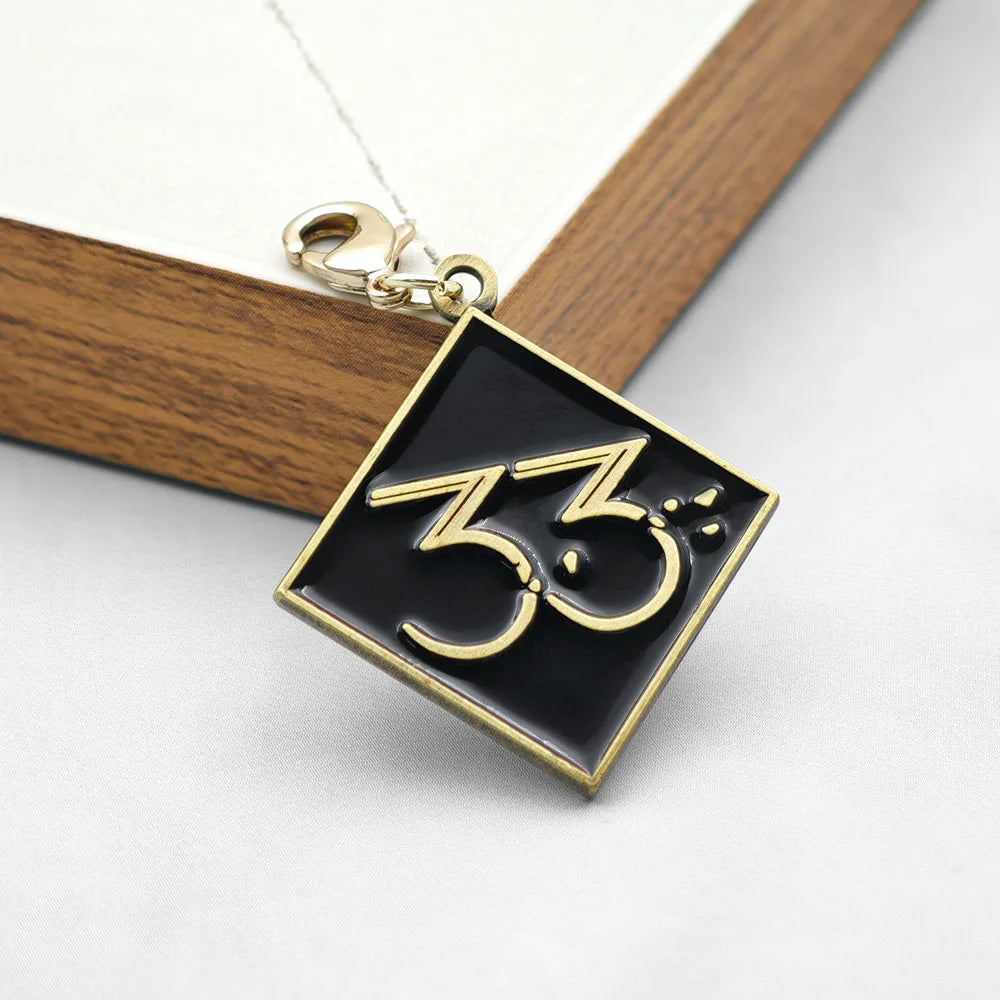 Expedition 33 Double-Sided Metal Keychain